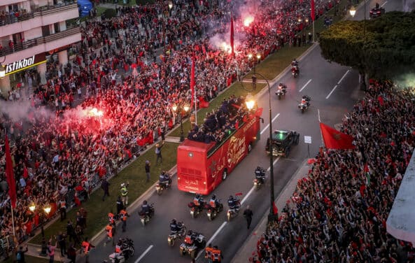 Supporters cheer as Morocco's national football team arrives to the center of the capital Rabat, on December 20, 2022, after the Qatar 2022 World Cup. (Photo by FADEL SENNA / AFP)